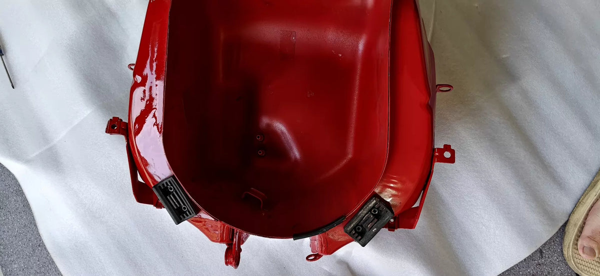 Red fuel tank for Ducati SuperSport 939, angled rear view showing overall condition and red paint finish
