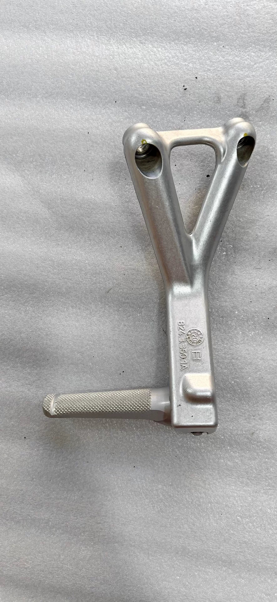 Ducati Panigale V4 footpeg bracket pair laid flat, full overview of both left and right anodized billet components