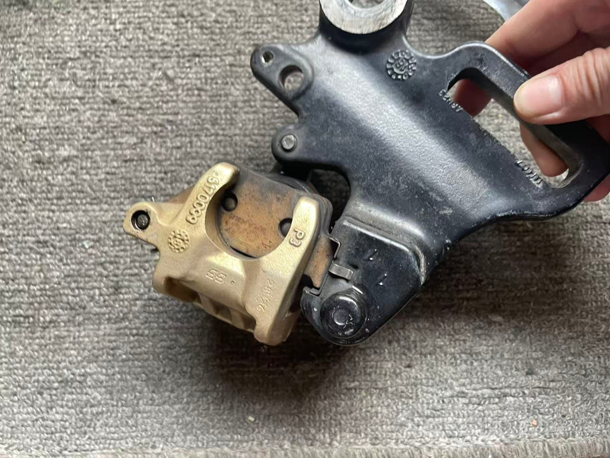 BMW G 310 R brake caliper angled view displaying overall condition and hardware fittings