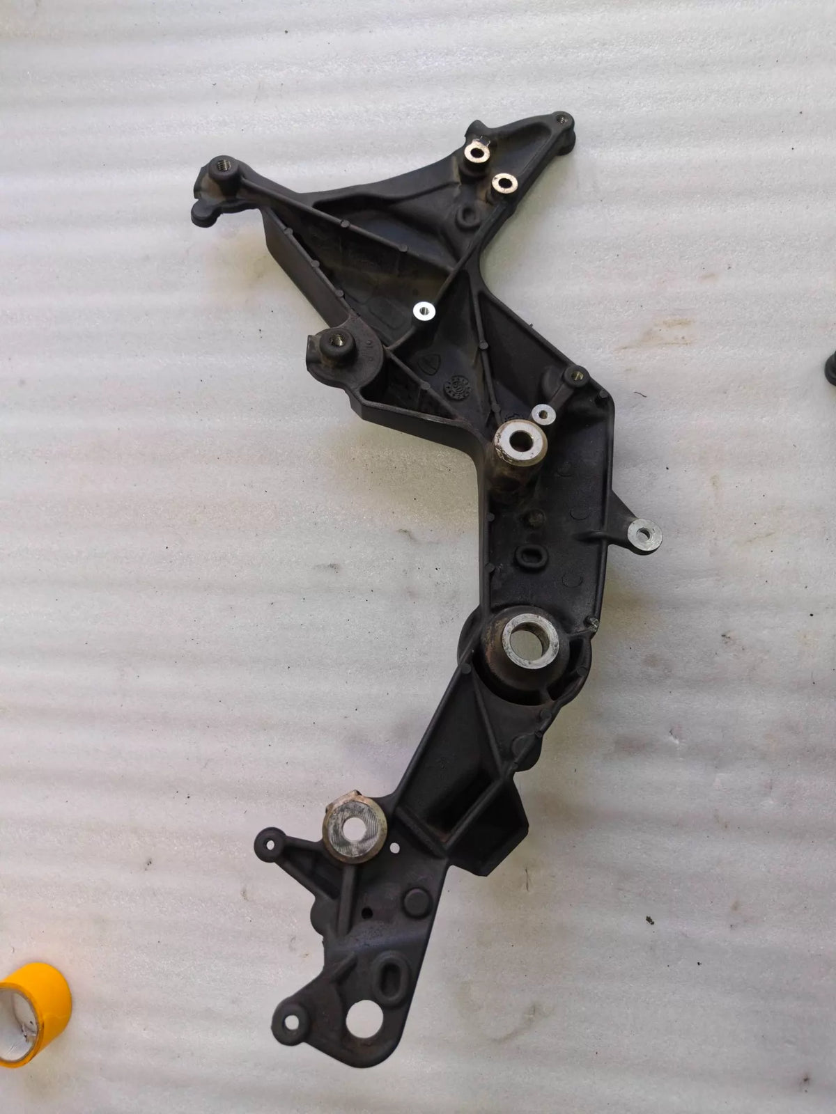 Ducati Multistrada 1200 footpeg bracket, underside view showing plate thickness and hardware detail