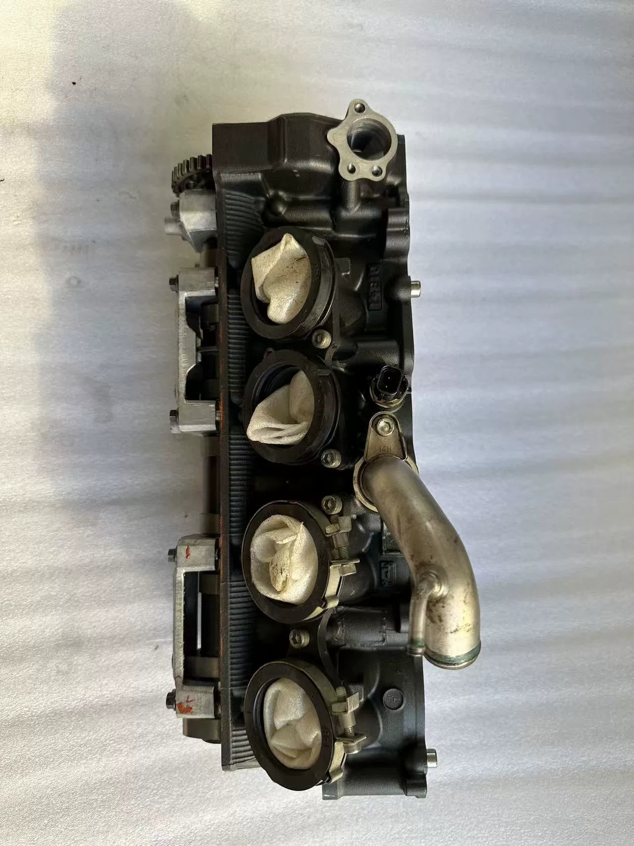 Intake port side of Yamaha YZF-R1 cylinder head, throttle bores plugged, coolant pipe attached, used