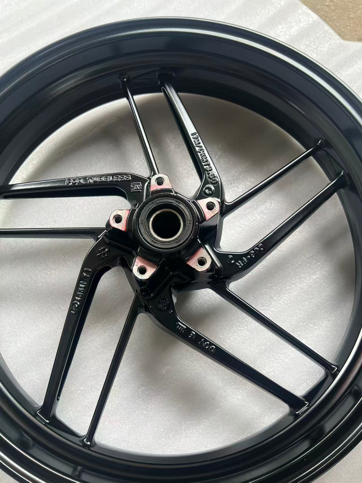 Ducati Monster 821 front wheel, detail shot of spoke and rim junction, surface wear visible