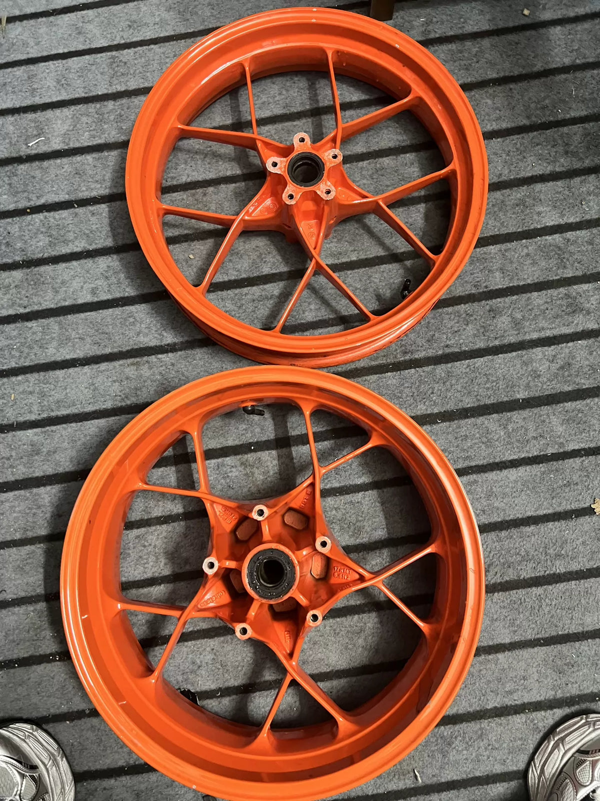 Orange electric front wheel for KTM 790 Duke, full front view showing hub and spokes