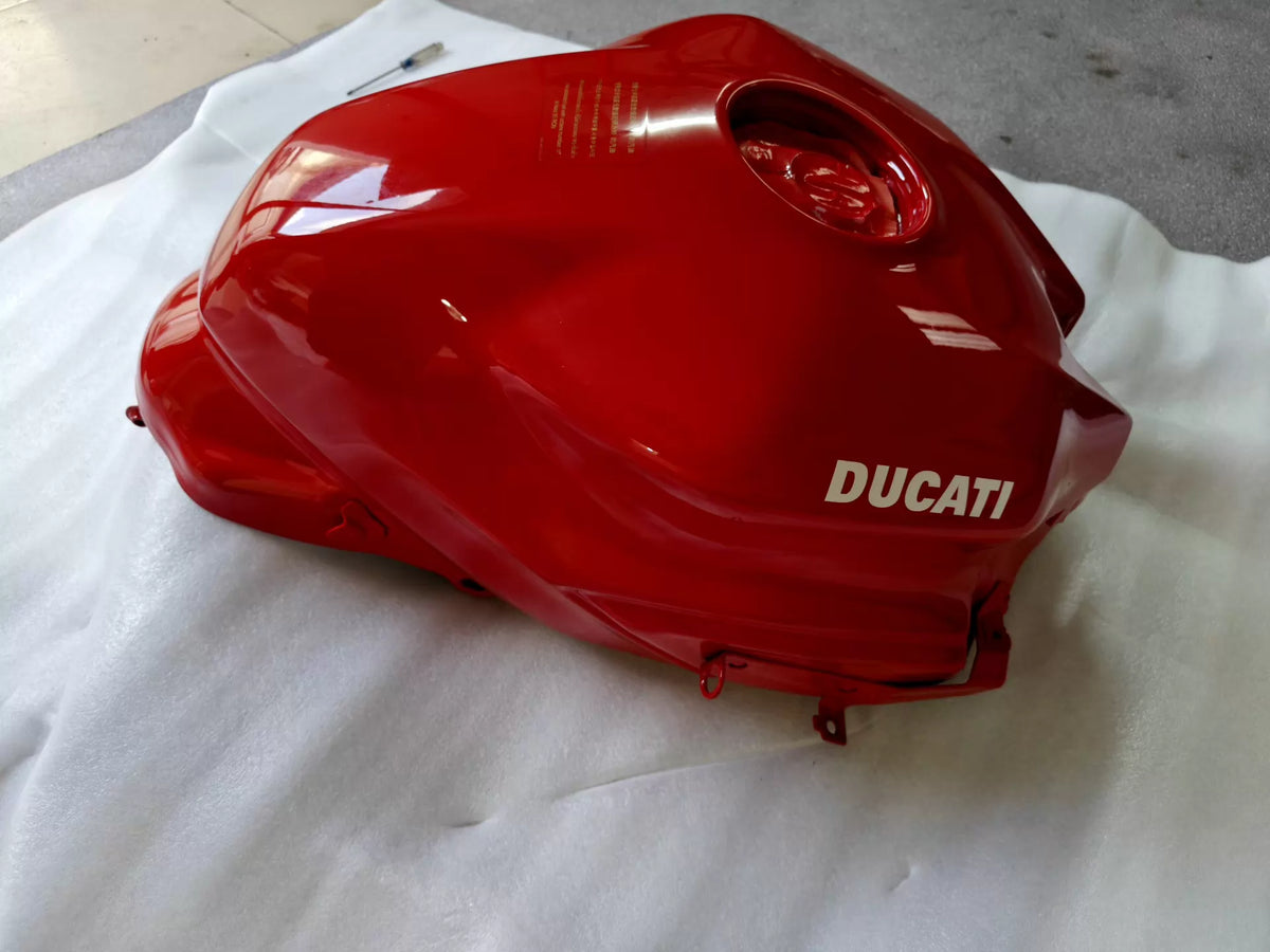 Red fuel tank for Ducati SuperSport 939, front three-quarter view showing smooth bodywork and filler cap