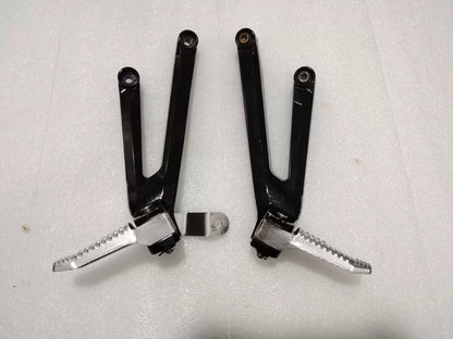 BMW S1000RR footpeg bracket, front angle view showing mounting points and machined aluminum construction
