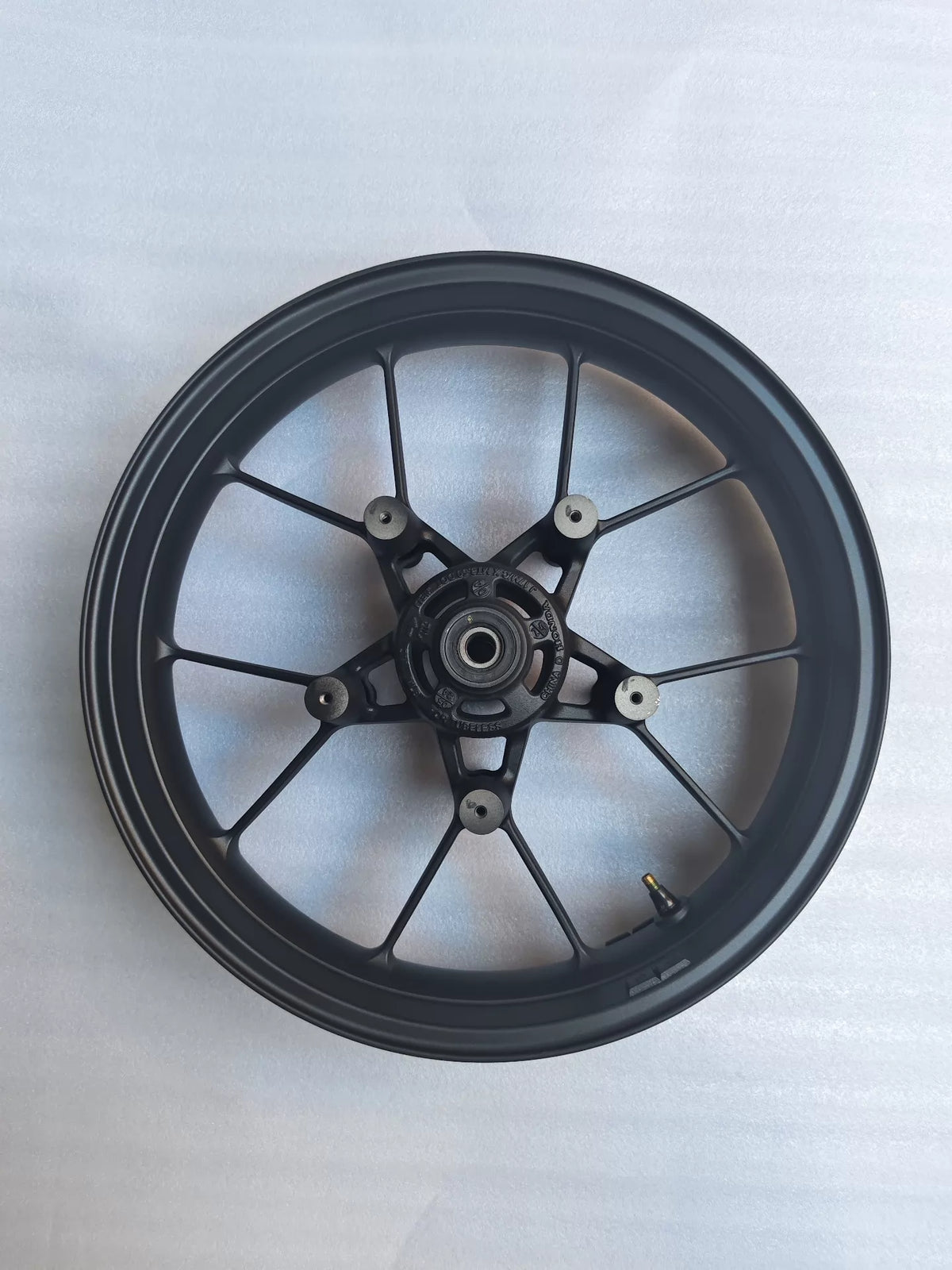 Front wheel rim for Honda CBR 500R shown at a slight angle revealing spoke pattern and hub center detail