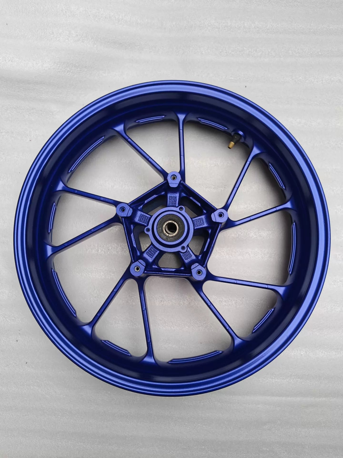 Blue front cast wheel for Yamaha MT-07 FZ-07, full top view, 10-spoke design with valve stem, clean condition