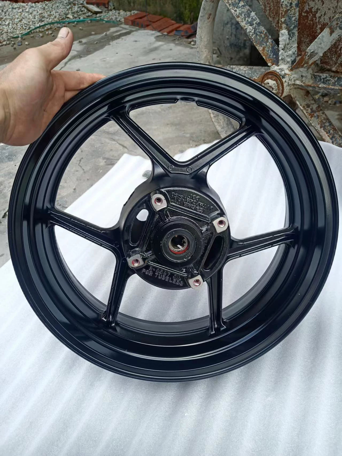Rear wheel assembly gloss black Kawasaki Z800, front angle view showing spokes and hub detail