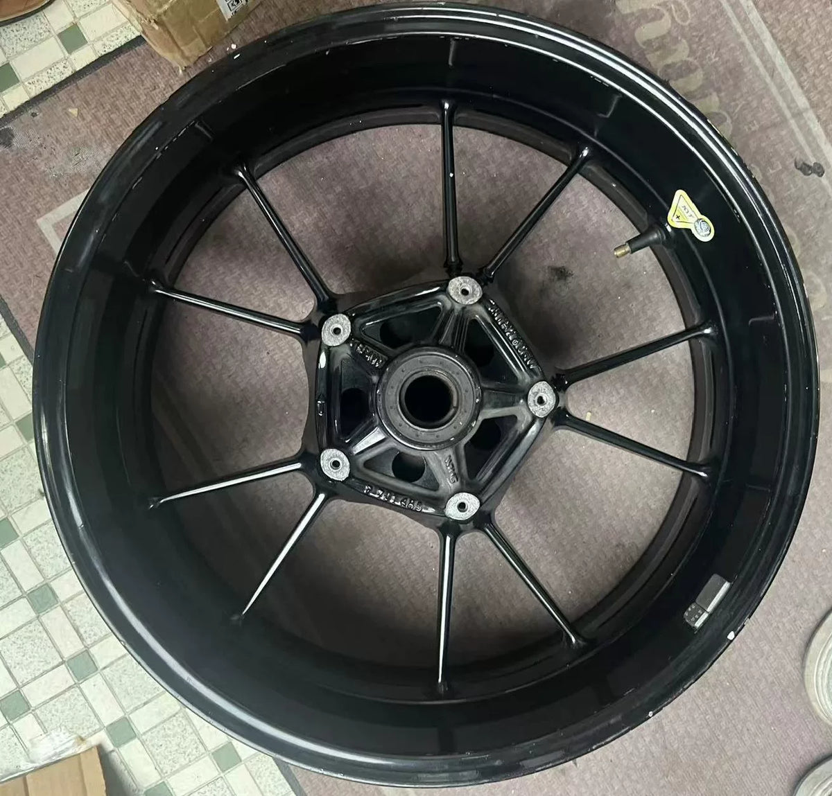 Rear rim for BMW S1000RR shown at front angle, silver spokes, clean condition