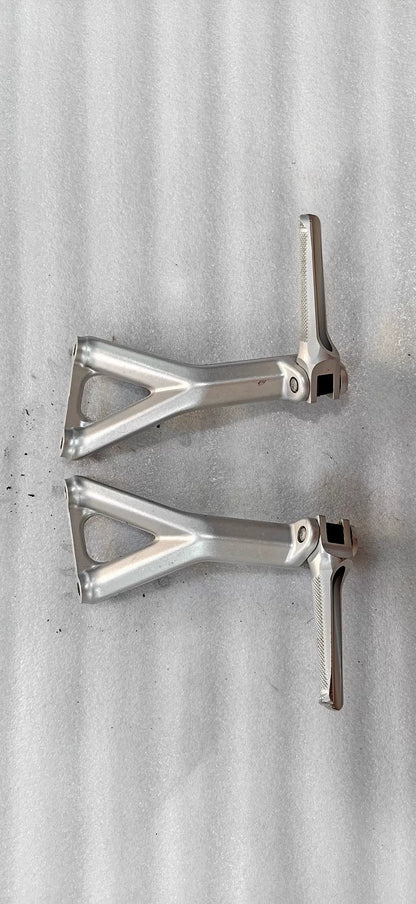 Ducati Panigale V4 rear sets footpeg bracket, angled top view showing machined aluminum construction and mounting hardware