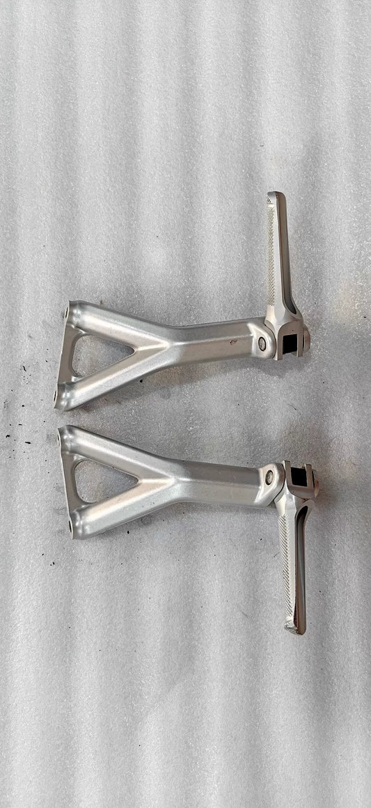 Ducati Panigale V4 rear sets footpeg bracket, angled top view showing machined aluminum construction and mounting hardware