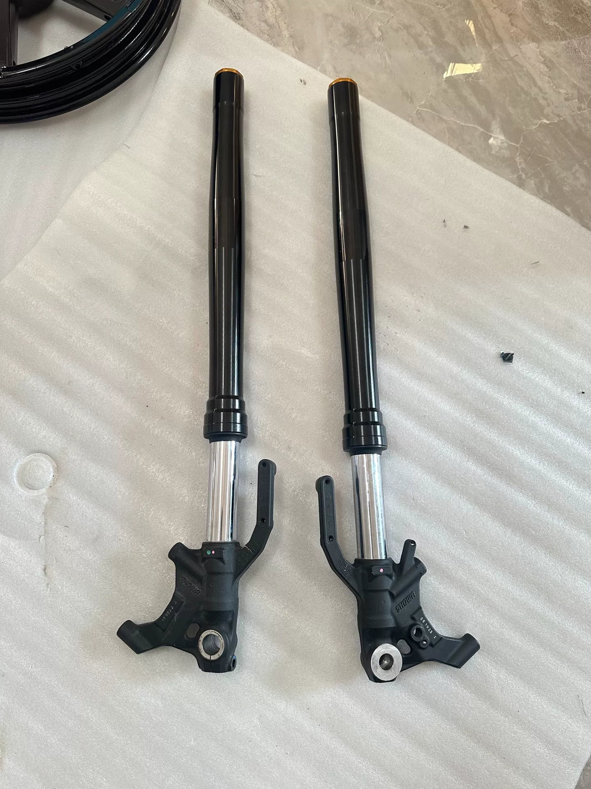 Front view of ZX-4RR right fork damper assembly laid flat, full length visible, OEM replacement part
