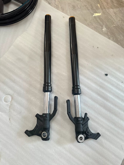 Front view of ZX-4RR right fork damper assembly laid flat, full length visible, OEM replacement part