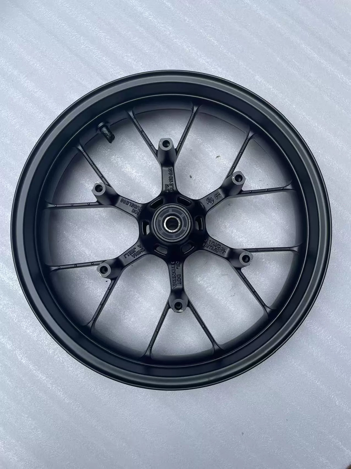 Honda CBR 500R front wheel rim straight, full side profile view showing spokes and hub center