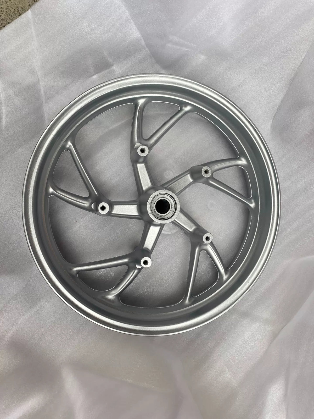 BMW K1600GT front rim, straight-on face view showing spokes and hub, silver finish, good used condition