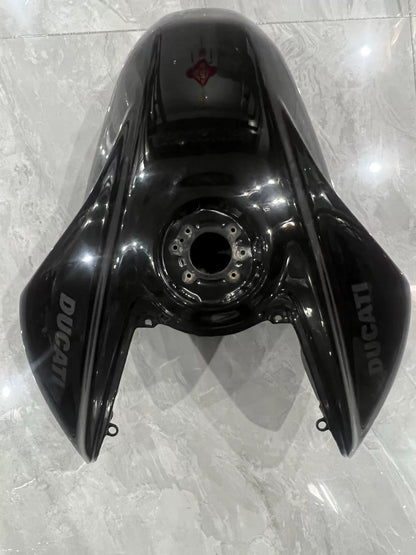 Ducati Diavel V4 black gas tank front angle view showing sleek contoured body and filler cap