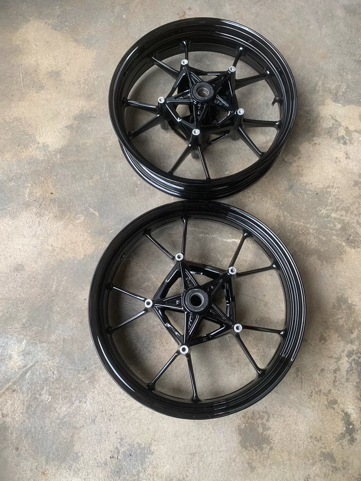 BMW S1000RR wheel set front wheel shown at angle, silver spokes and hub, clean condition