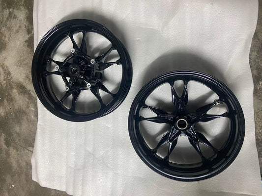 BMW C400X front wheel rim, full face view showing spoke pattern and hub center, clean used condition
