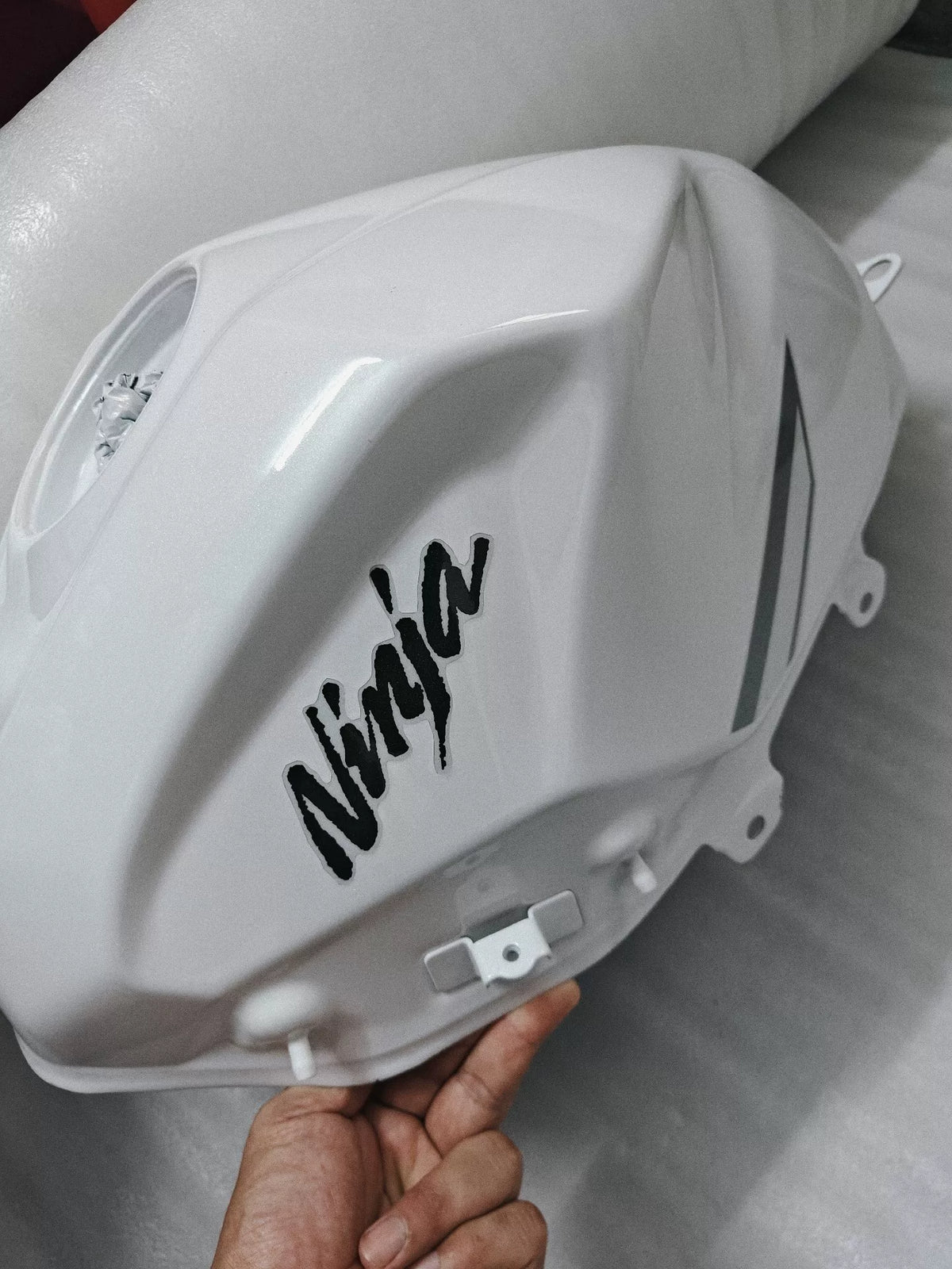 Kawasaki Ninja 400 white fuel tank comp front view showing smooth finish and mounting points