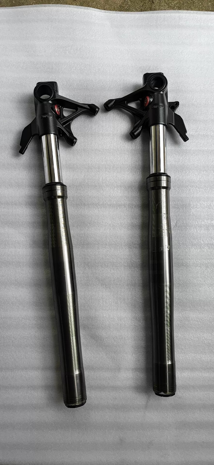 Ducati Panigale V2 front fork pair, full length front view, silver tubes with black lower legs, good condition