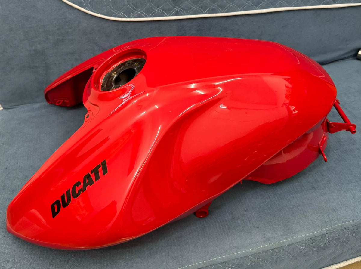 Gloss red fuel tank for Ducati Diavel V4, front three-quarter view showing full bodywork shape and finish