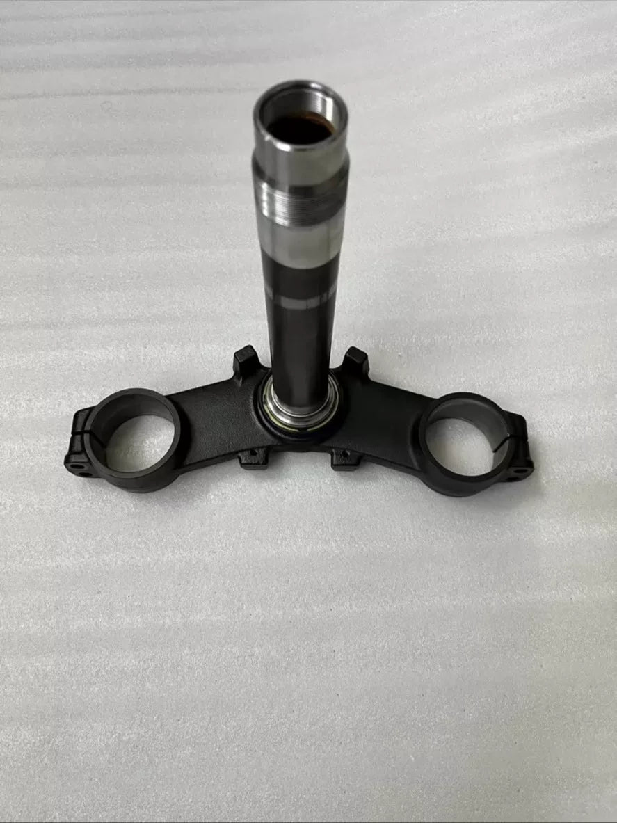 Kawasaki Z900 triple clamp front view showing upper and lower yoke assembly, machined aluminum finish, clean condition
