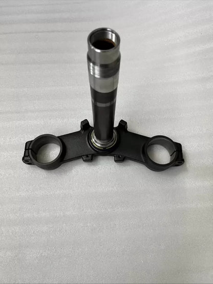 Kawasaki Z900 triple clamp front view showing upper and lower yoke assembly, machined aluminum finish, clean condition