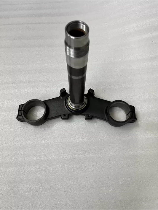 Kawasaki Z900 triple clamp front view showing upper and lower yoke assembly, machined aluminum finish, clean condition