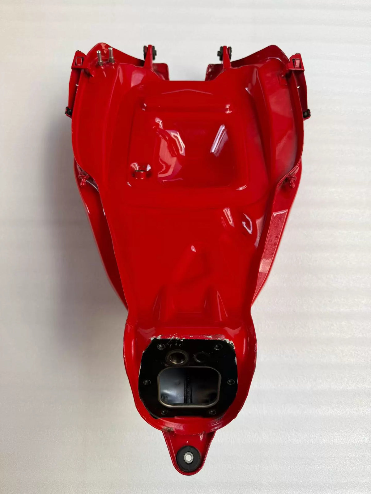 Red fuel tank for Ducati Panigale V2, close-up front view highlighting paint finish and tank shape