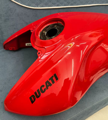 Gloss red Diavel V4 fuel tank, side profile view highlighting smooth contours and paint quality