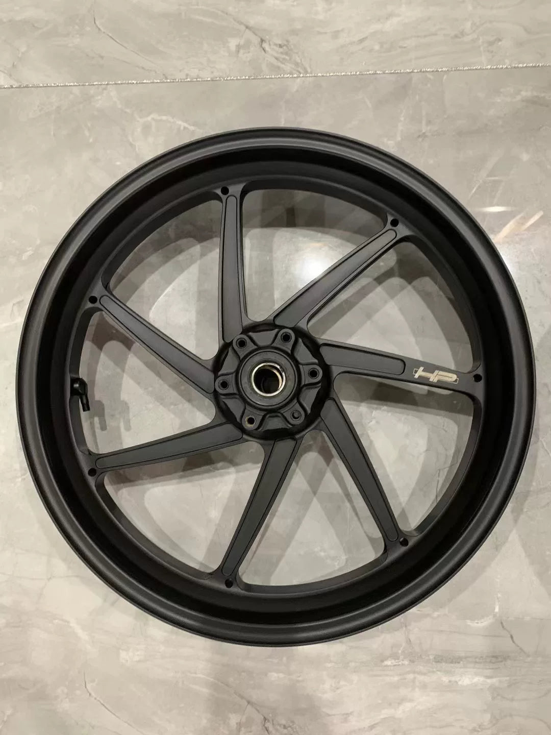 BMW S1000RR forged M HP front wheel close-up of hub center and bearing area, angled view