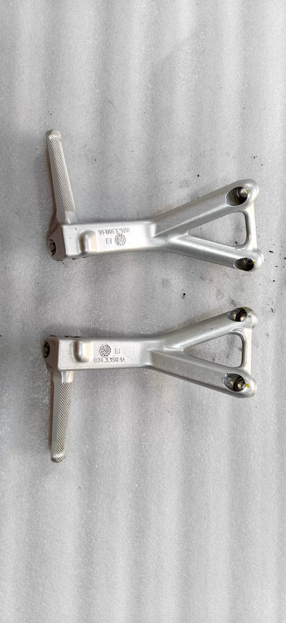 Ducati Panigale V4 footpeg bracket set, front view displaying left and right billet aluminum arms with pivot points