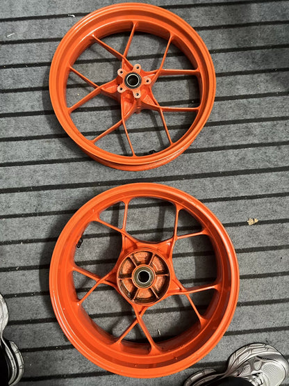 Orange electric rear wheel for KTM 790 Duke, side angle showing rim and tire mount