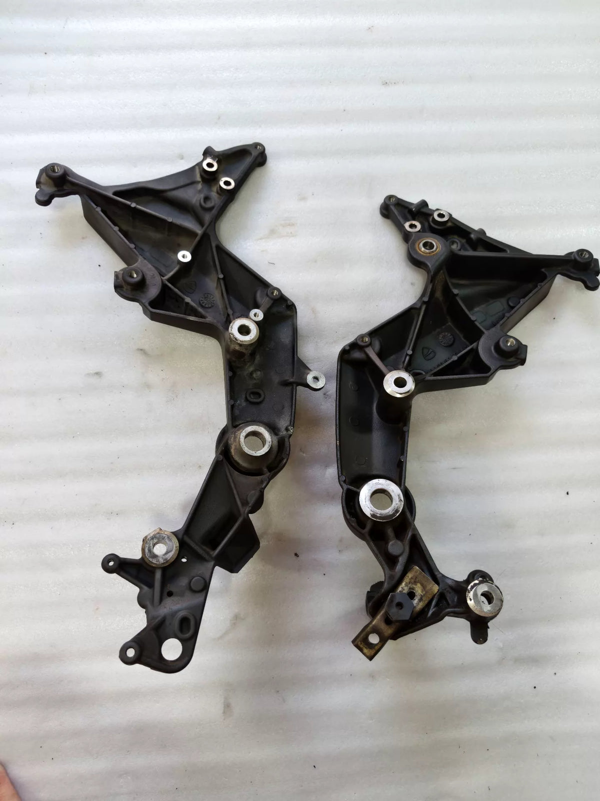 Ducati Multistrada 1200 footpeg bracket, rear angle view displaying bracket arm and pivot hardware