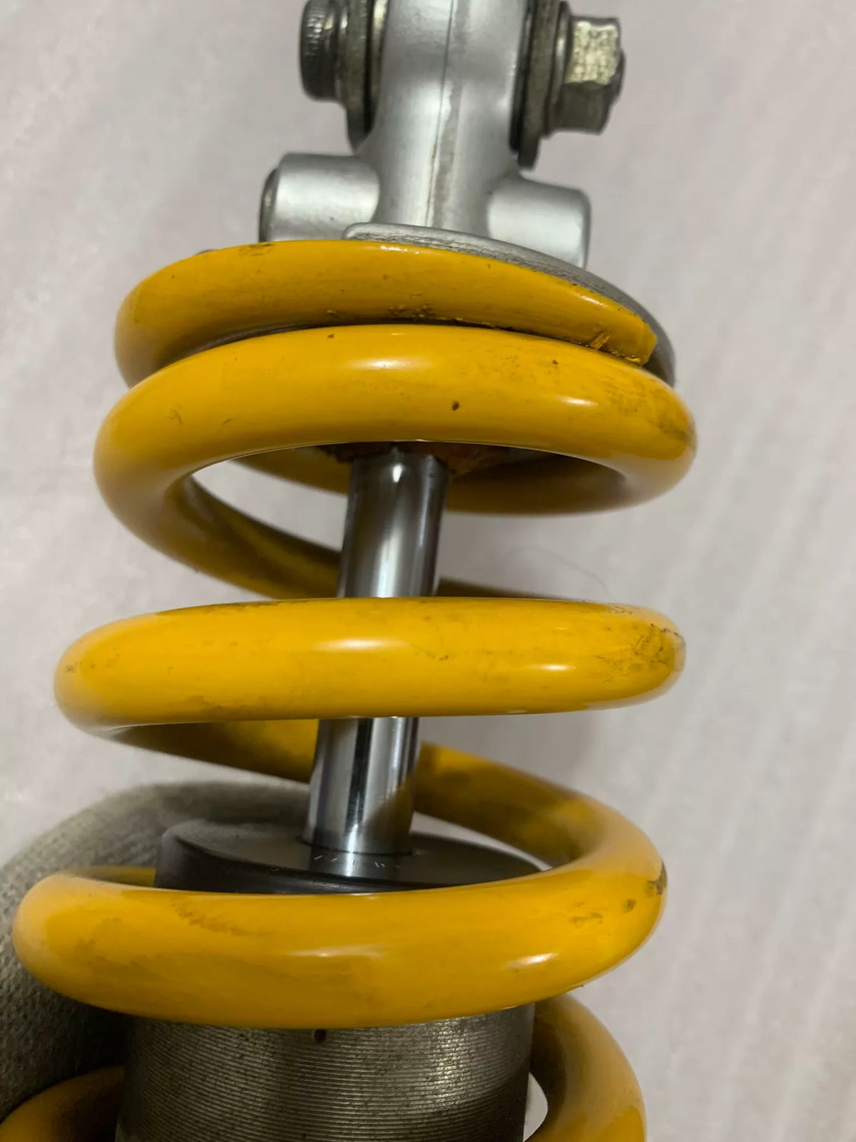 Ducati Monster 796 rear shock top mount and reservoir detail, close-up angle
