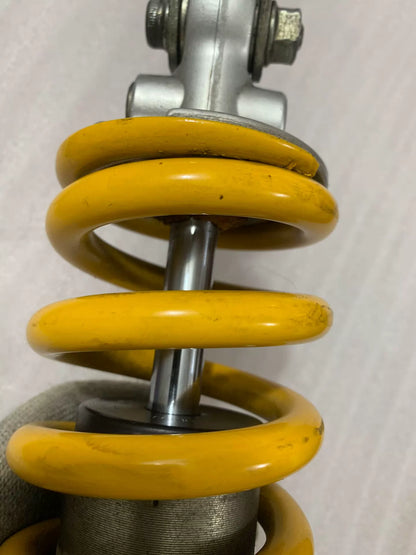 Ducati Monster 796 rear shock top mount and reservoir detail, close-up angle