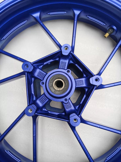 Rear hub view of blue cast front wheel for Yamaha MT-07 FZ-07 showing 5-spoke bearing bore and disc mount holes
