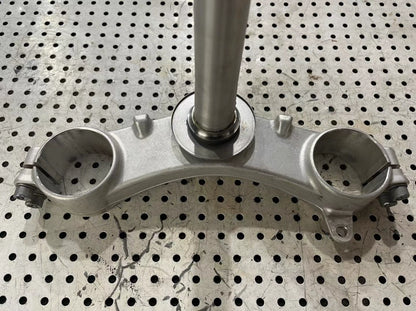 BMW S1000RR triple clamp top-down angle displaying machined aluminum upper clamp and mounting holes