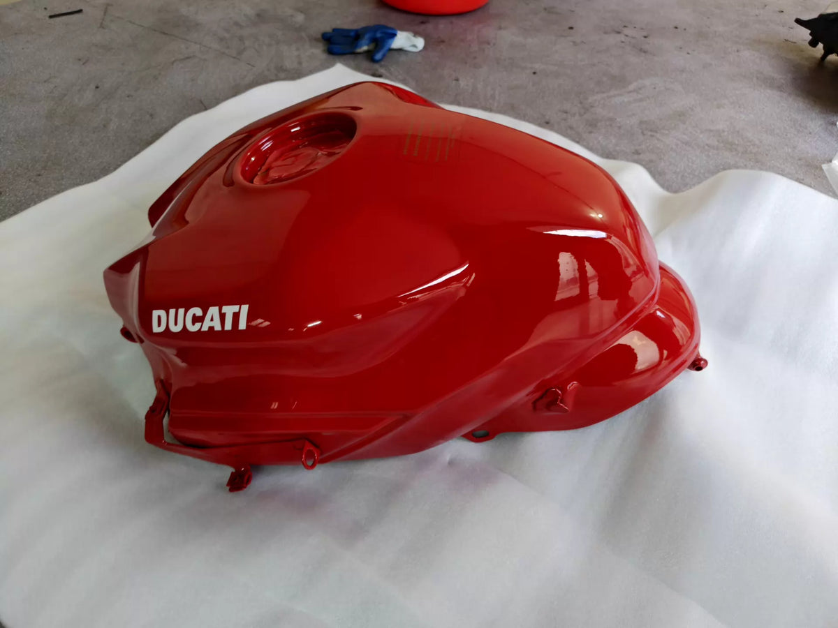 Red fuel tank for Ducati SuperSport 939, rear angle view displaying mounting points and contoured shape