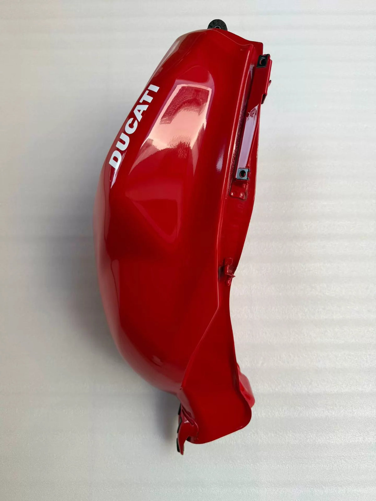 Red fuel tank for Ducati Panigale V2, rear angle showing fuel cap recess and underside mounting brackets