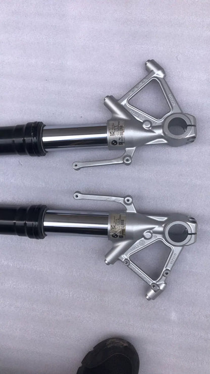BMW S1000R fork leg pair, angled side view displaying full length of polished tubes and axle clamps