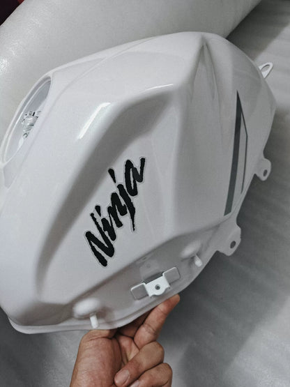 Kawasaki Ninja 400 white fuel tank side profile view displaying contour lines and clean condition