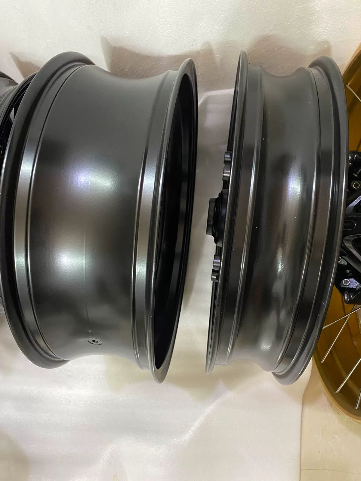 BMW R nineT cast rear rim, angled side view displaying wide flange and machined finish