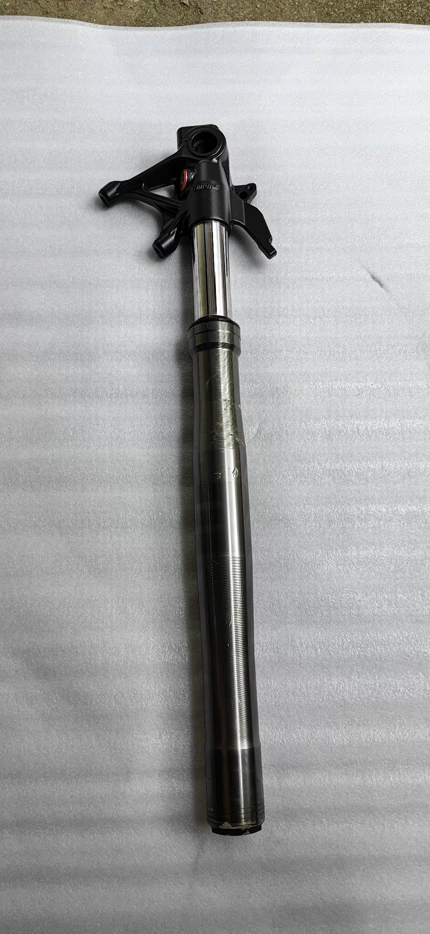 Ducati Panigale V2 front fork assembly, angled side view showing upper tubes and triple clamp area