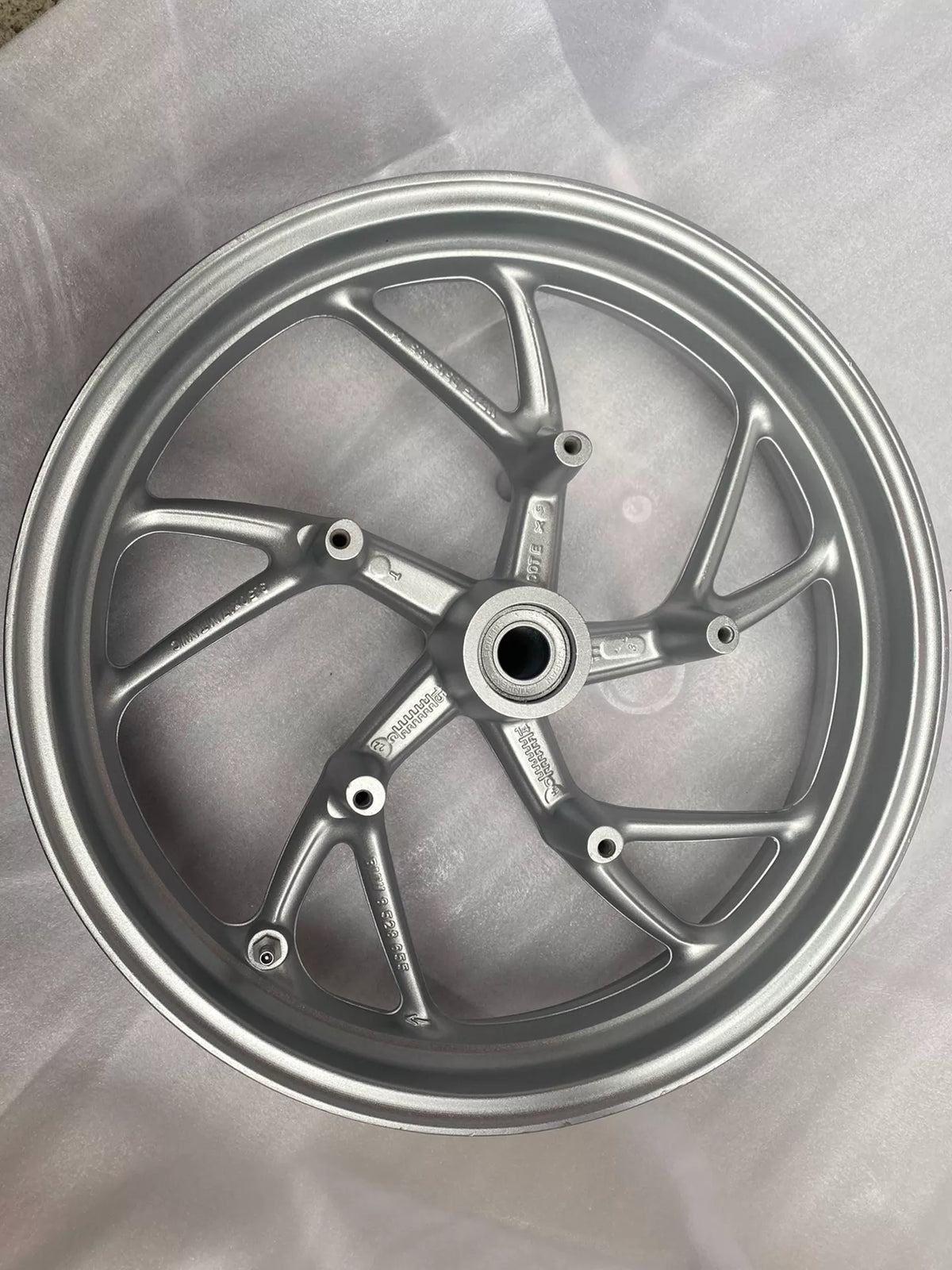 BMW K1600GT front rim, angled side profile view highlighting rim depth and spoke pattern, clean condition