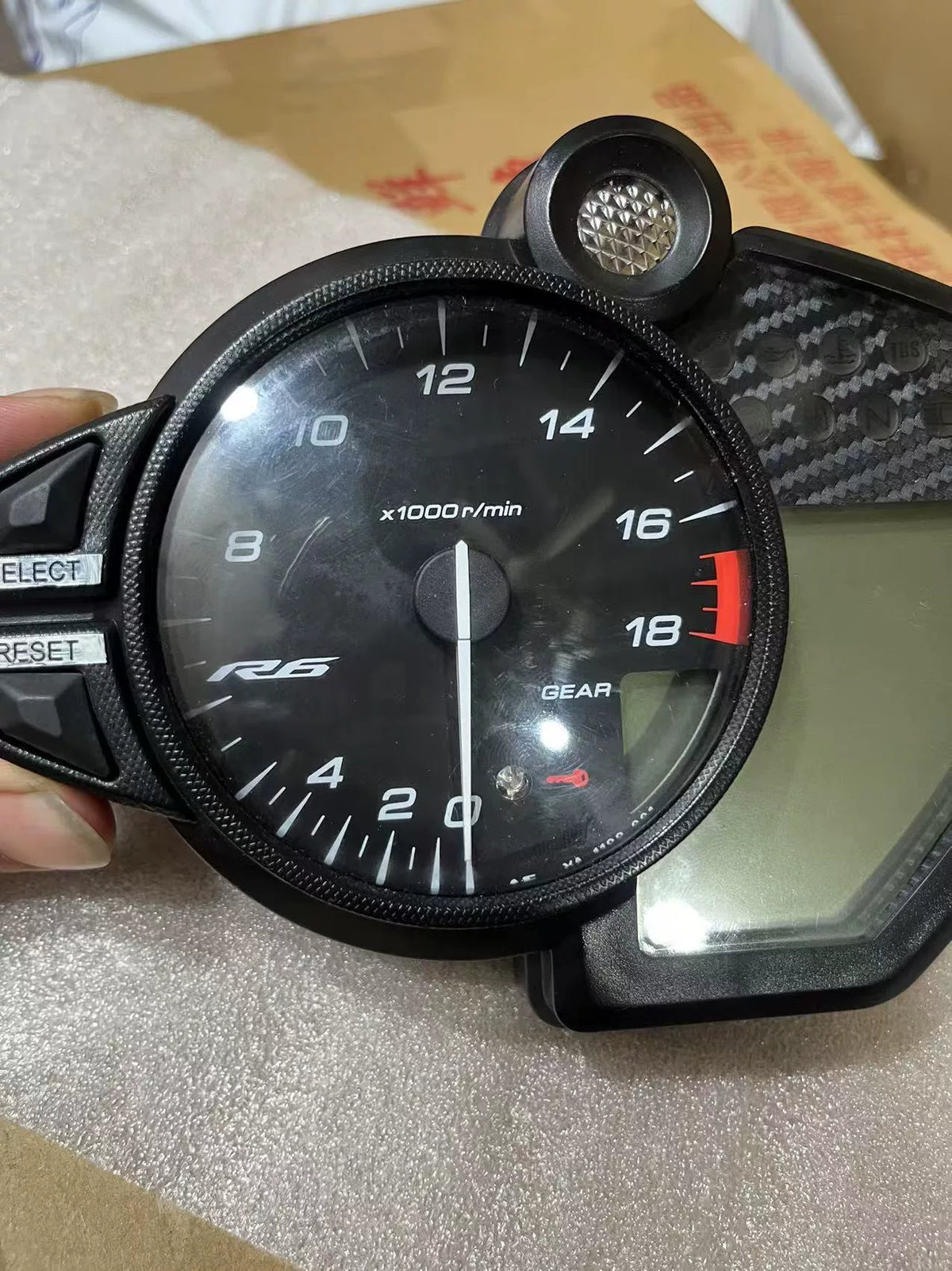 Yamaha YZF-R6 instrument cluster angled view displaying digital LCD display and gauge cluster detail