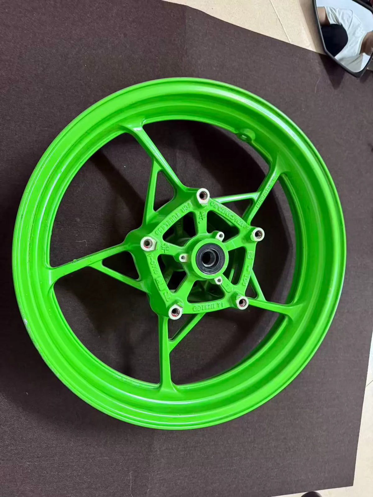 Anniversary edition green front wheel ZX-4RR, angled side profile highlighting green finish and tire fitment