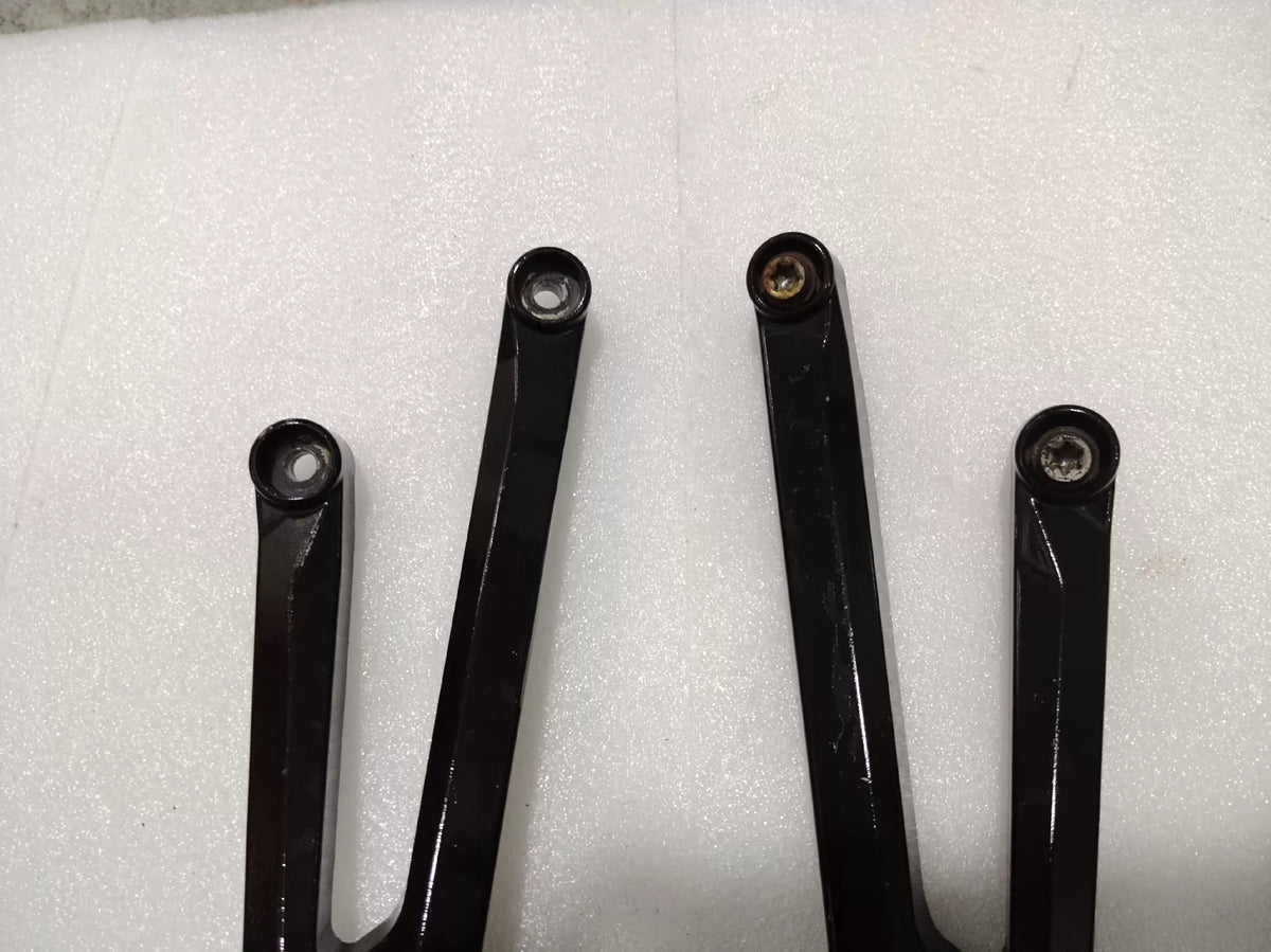 BMW S1000RR footpeg bracket, side profile view displaying full bracket shape and bolt hole positions
