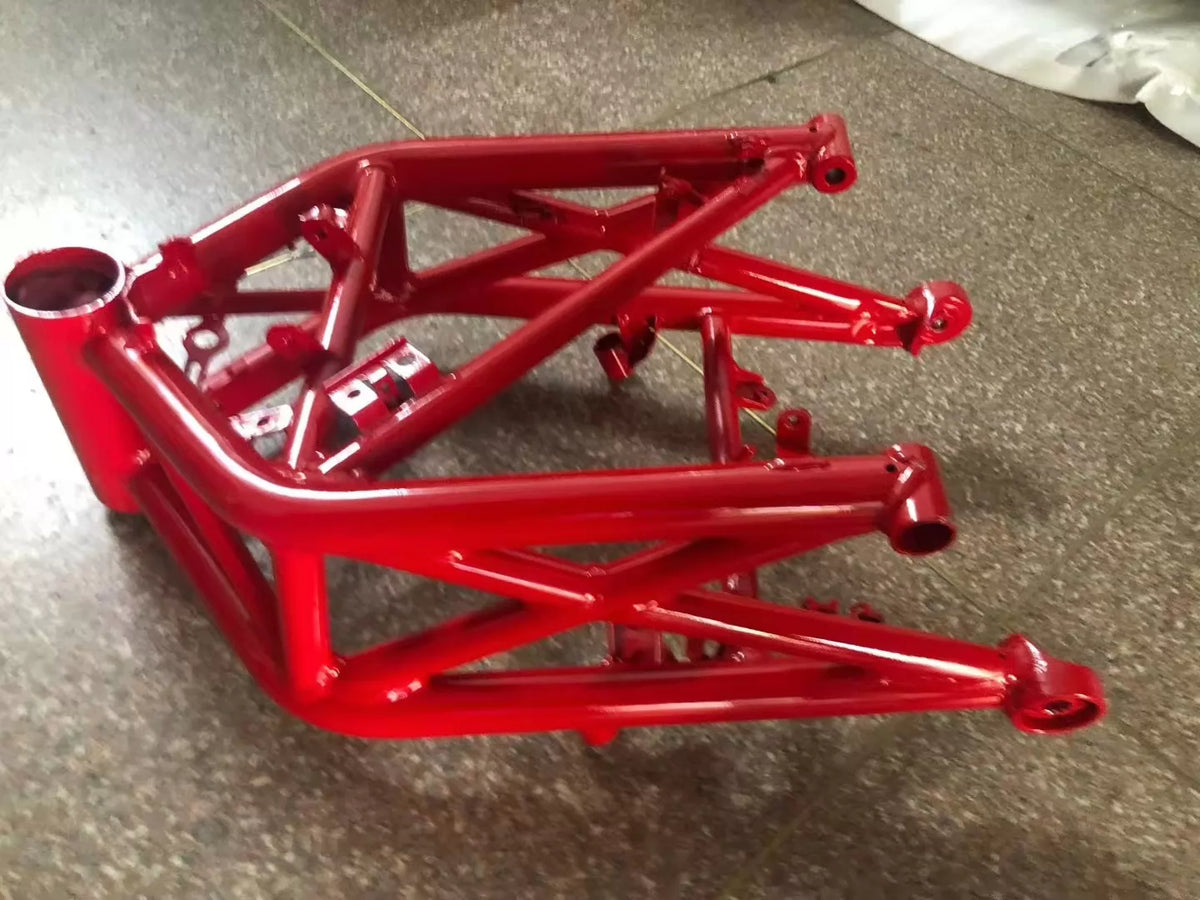 Ducati Monster 696 frame, left side view displaying swingarm pivot and subframe mounting points, bare metal