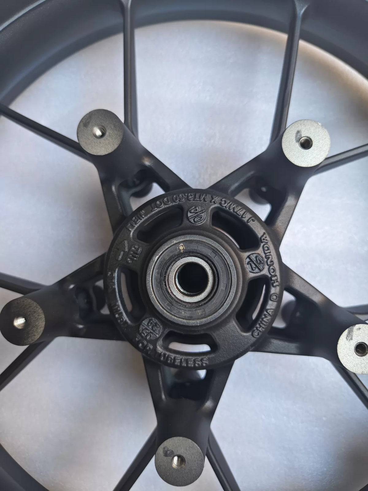 Honda CBR 500R front wheel rim displayed flat-on showing full circular profile and valve stem hole position